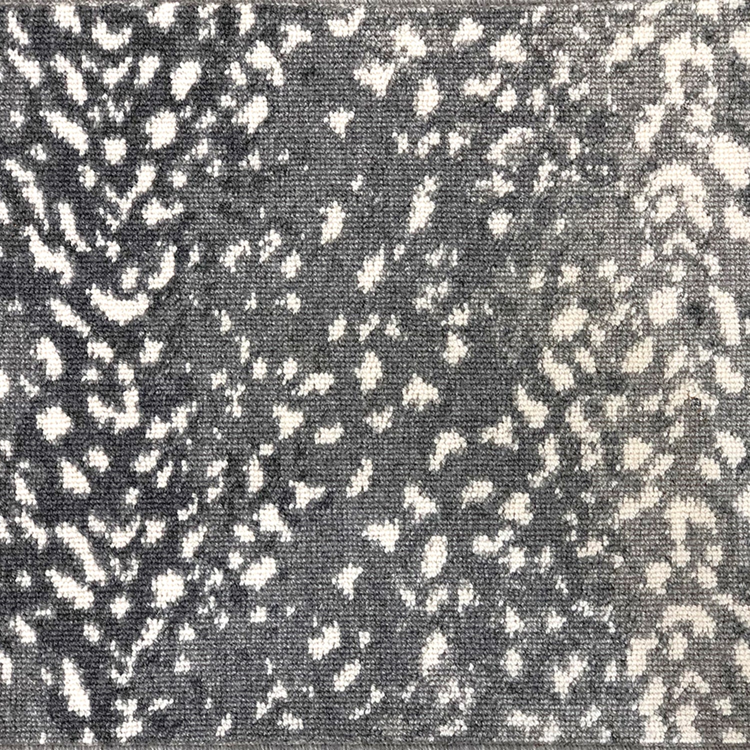 Wool broadloom carpet swatch in a white leopard print on an ombré background in shades of blue-gray.