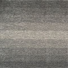 Wool broadloom carpet swatch in an ombré weave in shades of cream, gray and charcoal.