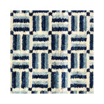 Woven rug detail in a small-scale crosshatch pattern in shades of blue, black and cream.