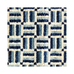 Woven rug detail in a small-scale crosshatch pattern in shades of blue, black and cream.