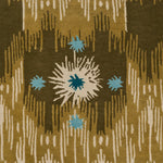 Detail of Estrella Rug in Lichen features a painterly abstract ikat in shades of olive and ecru with star shaped accents in cyan and teal