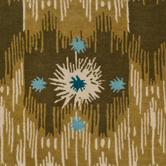 Detail of Estrella Rug in Lichen features a painterly abstract ikat in shades of olive and ecru with star shaped accents in cyan and teal