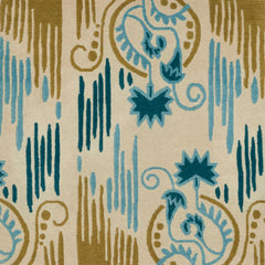 Detail of Fenwick Floral rug featuring a graphic floral motif paired with a painted linear design in cyan, teal and chartreuse on an ivory background