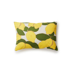 A rectangular throw pillow with a large-scale lemon and leaf print in yellow and green on a gray background.
