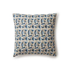 A square throw pillow with a repeating pattern of large-scale graphic flowers in blue and navy on a tan background.