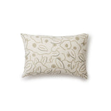 A rectangular throw pillow in a large-scale minimal floral print in shades of tan and brown on a cream background.