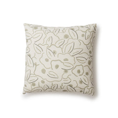 A square throw pillow in a large-scale minimal floral print in shades of tan and brown on a cream background.