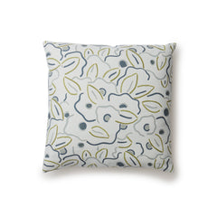 A square throw pillow in a large-scale minimal floral print in shades of blue, green and gray on a light blue background.