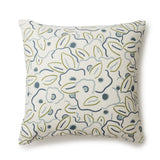 A square throw pillow in a large-scale minimal floral print in shades of blue, green and gray on a tan background.