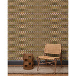 Wood and woven chair, brown stool and rug in front of wallpaper with a pattern of vertical stripes of pink, warm olive green and dashes of yellow and white, hover