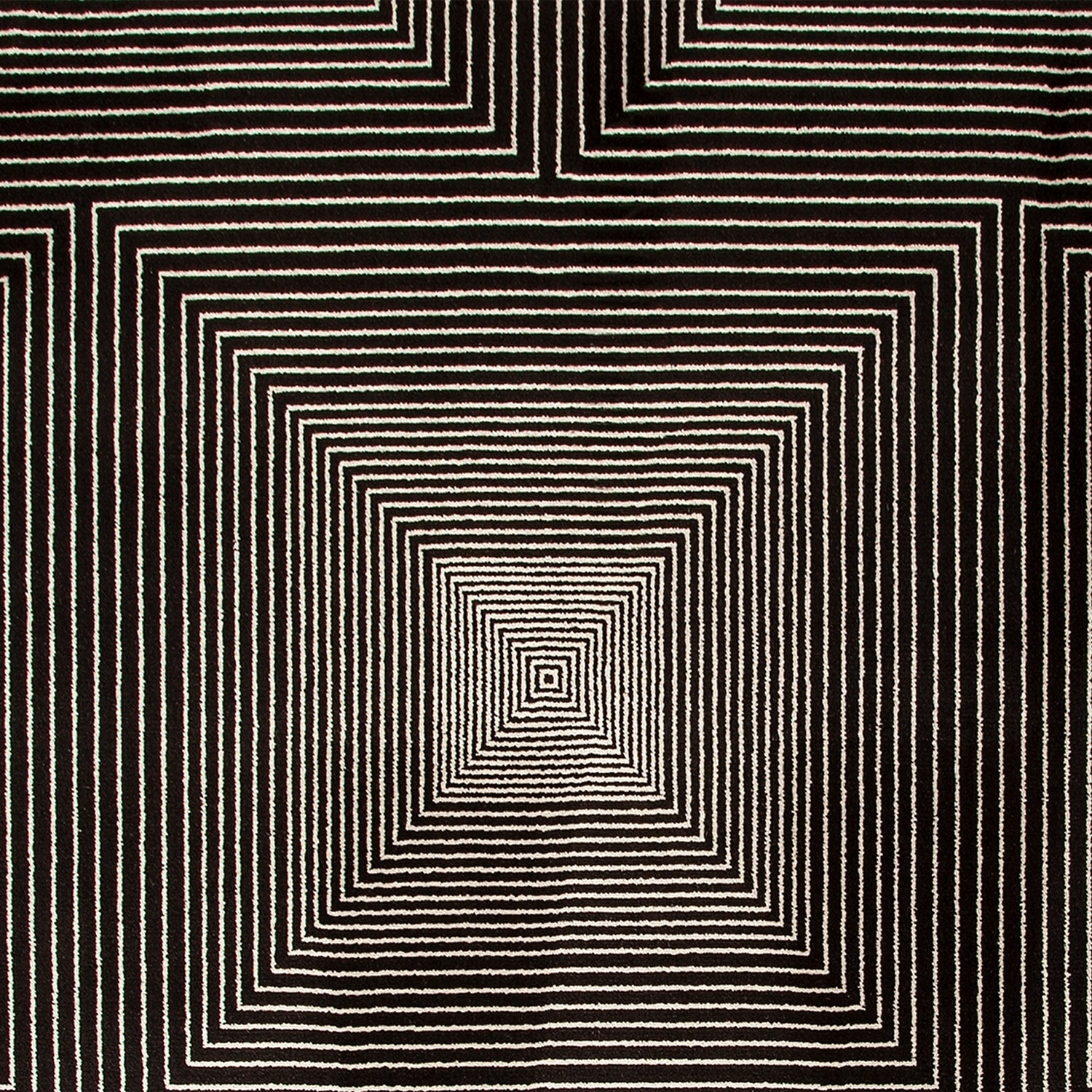 Detail of a wool-silk broadloom carpet swatch in a dense linear square print in white on a black field.