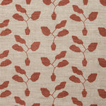 Fabric swatch with a three leafed plant in a pot motif in warm coral on a textured woven linen in oatmeal.