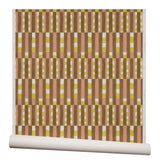 Wallpaper roll with a pattern of vertical stripes of pink, warm olive green and dashes of yellow and white.