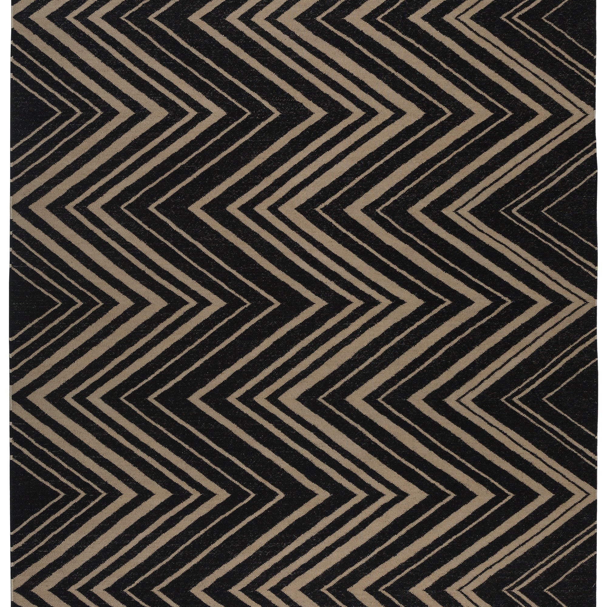 Vertical Zig-Zag Rug in Onyx-Sandstone, a zig zag pattern in mixed widths in black and taupe with a fringed edge. 