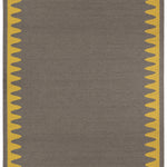 Waver Rug in Cardinal Yellow, a dark taupe field with a yellow flame stitch border. 