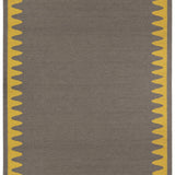 Waver Rug in Cardinal Yellow, a dark taupe field with a yellow flame stitch border. 