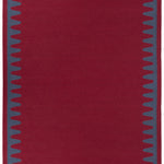 Waver Rug in Queensdown Red, a solid red field with a blue flame stitch border. 