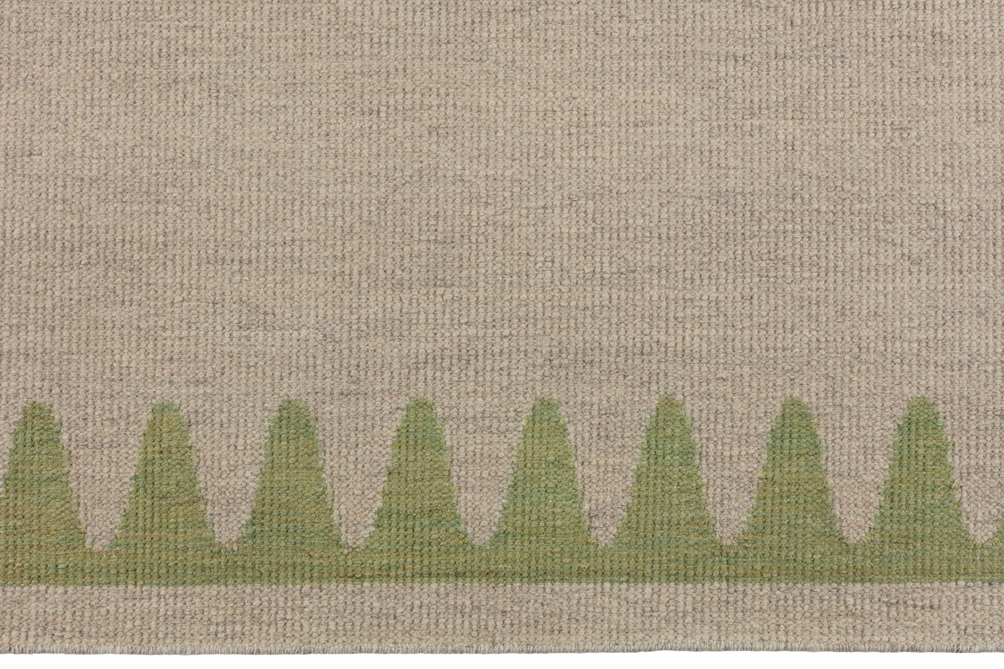 Detail of the Waver Rug in Sage, a strated taupe field with a sage green flame stitch border. 