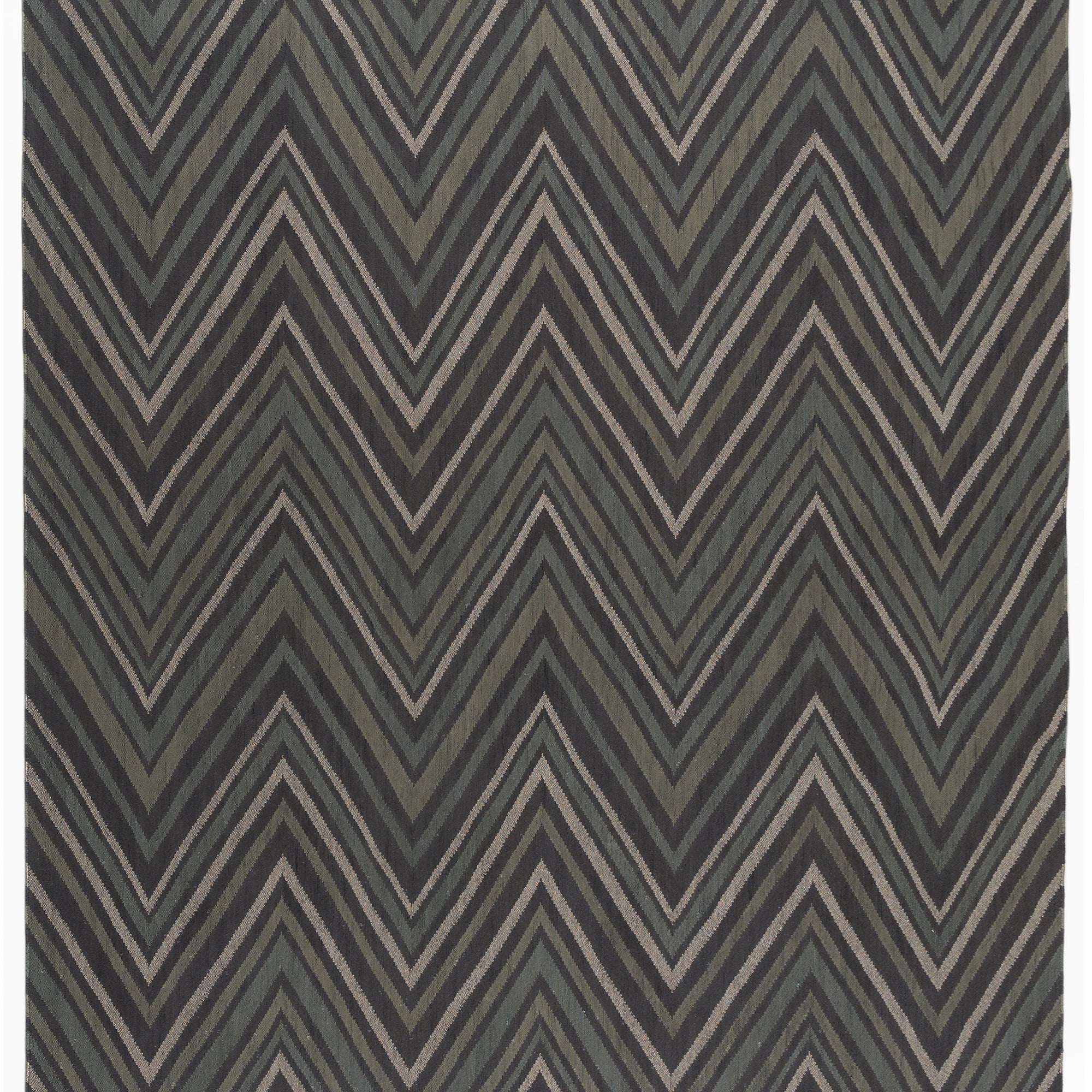 Full size To The Point Rug in Pyrite-Metallic, a zig zag pattern in dark greens, metallic ecru and black, with a mulit color tasseled edge. 