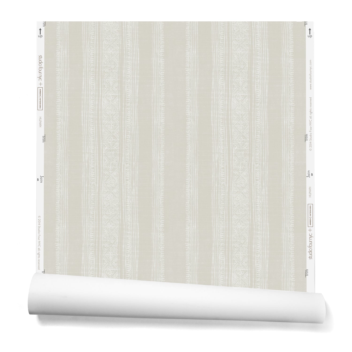 A partially unrolled roll of wallpaper in a striped pattern of intricate white lines over a washed beige background.