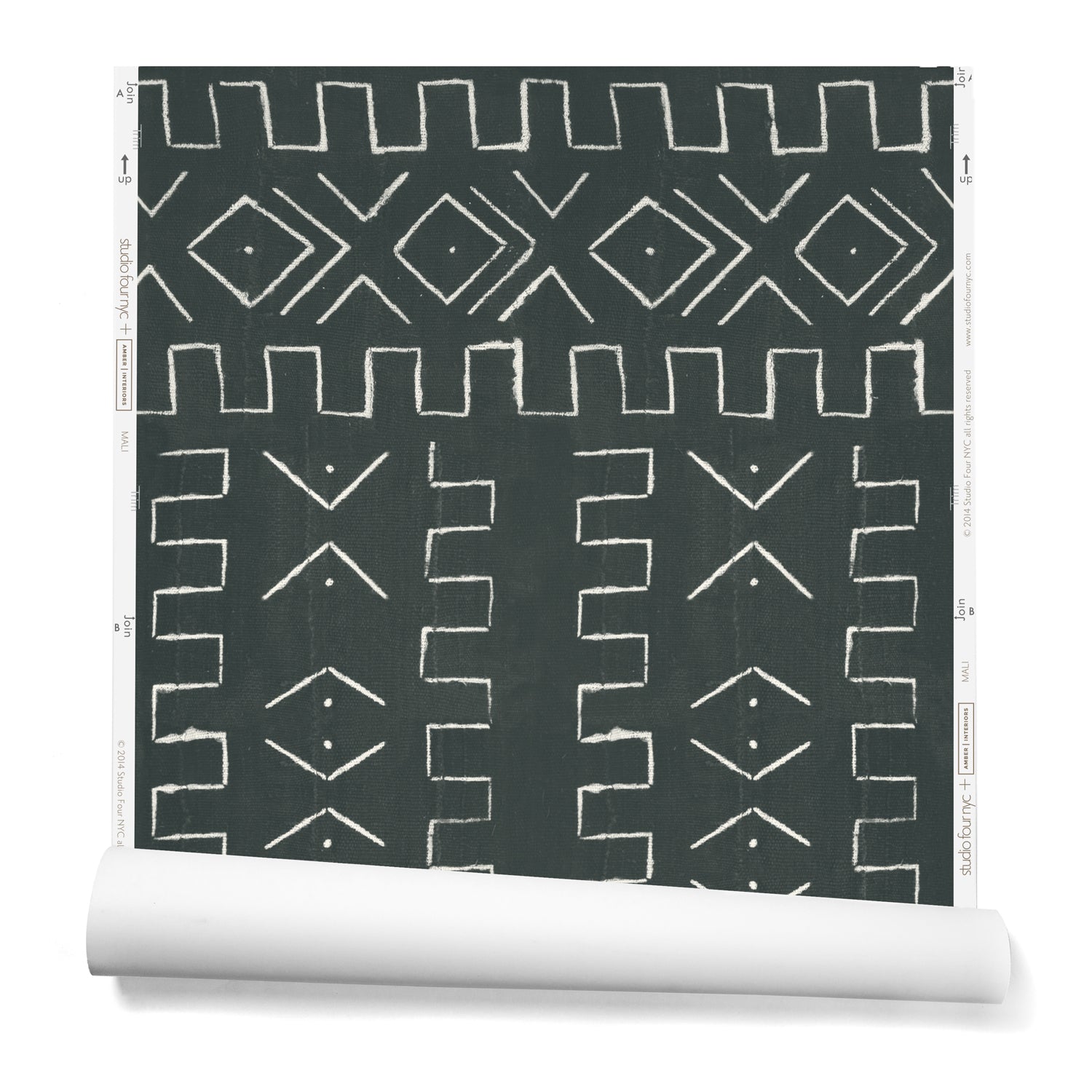 A partially unrolled roll of wallpaper in a minimalist African-inspired line design of painted white on a charcoal background.