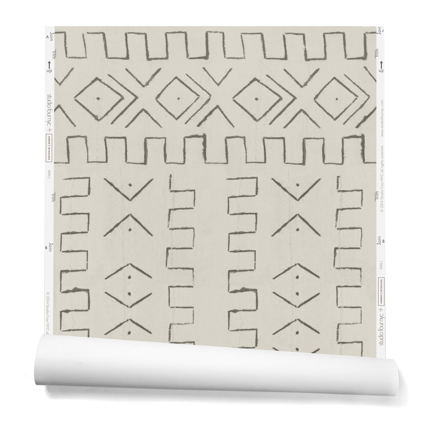 A partially unrolled roll of wallpaper in a minimalist African-inspired line design of painted gray on a beige background.