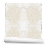 Partially unrolled wallpaper in a dense hand-drawn symmetrical pattern in shades of beige on a white background.