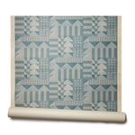 Abbot Kinney grasscloth roll: the design is geometric with triangles and squares in a teal color printed on textured grasscloth