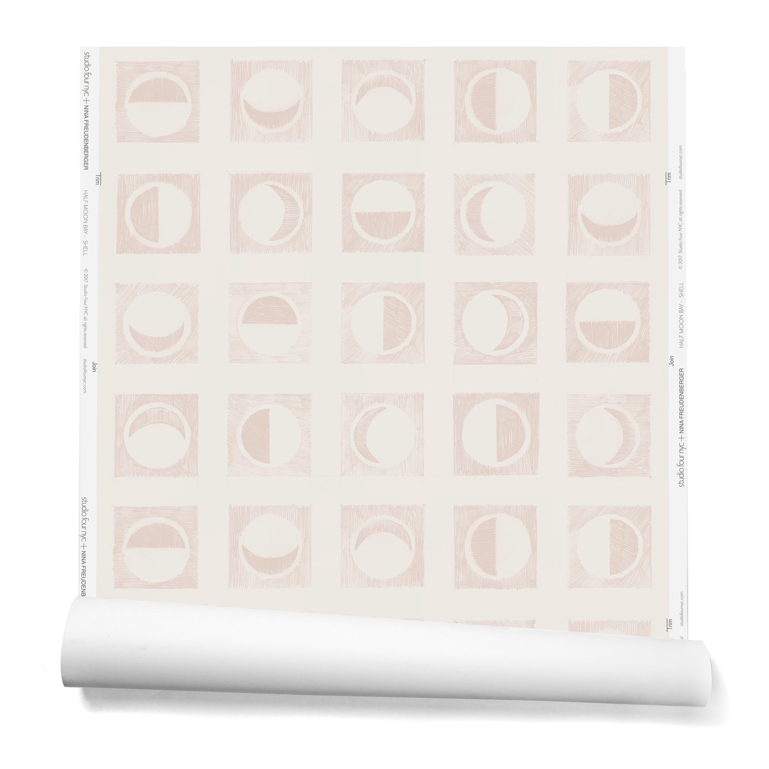 Partially unrolled wallpaper roll with rows of block-printed moons in various phases. Moons are light pink on a beige background.