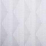 Sheer linen fabric swatch in a horizontal stripe pattern broken with triangluar shapes, in shades of white.