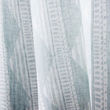 Close-up sheer linen fabric swatch in a horizontal stripe pattern broken with triangluar shapes, in shades of gray.