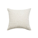 Square throw pillow with a large-scale repeating leaf print in white on a tan field.