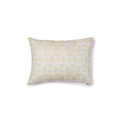 A rectangular throw pillow with a repeating pattern of large-scale graphic flowers in light blue and green on a cream background.