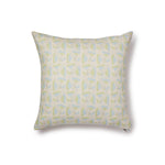 A square throw pillow with a repeating pattern of large-scale graphic flowers in light blue and green on a cream background.