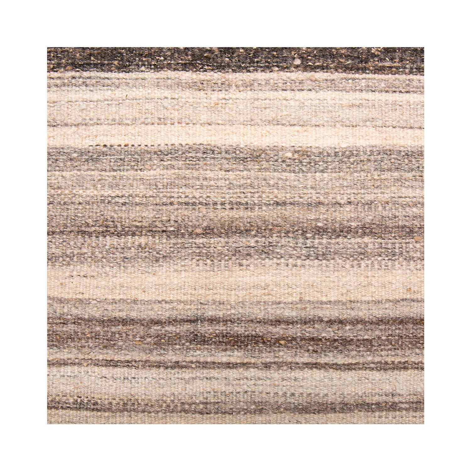 Woven rug detail in a stripe pattern in shades of cream, tan and light brown.