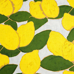 Fabric swatch with a large-scale painted lemon and leaf print in yellow and green on a light blue background.
