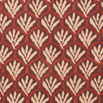 Woven fabric swatch with a repeating Moroccan-inspired scallop pattern in white and red on a maroon background.