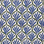 Woven fabric swatch with a repeating Moroccan-inspired scallop pattern in blue and green on a white background.
