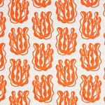 Woven fabric swatch with a repeating cartoon seaweed print in orange on a white background.