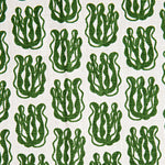 Woven fabric swatch with a repeating cartoon seaweed print in green on a white background.