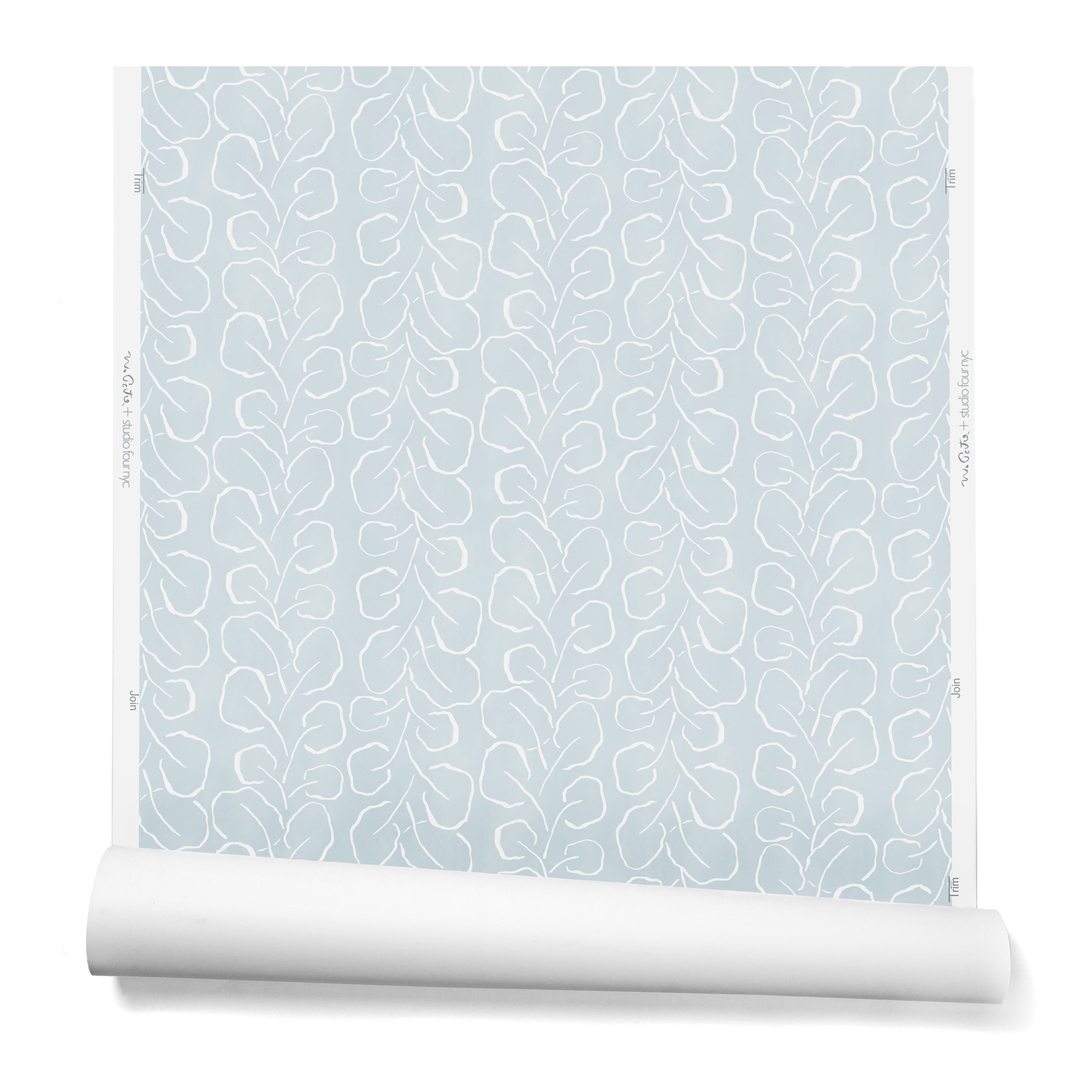 A hanging roll of wallpaper with a large-scale repeating leaf print in white on a light blue watercolor background.