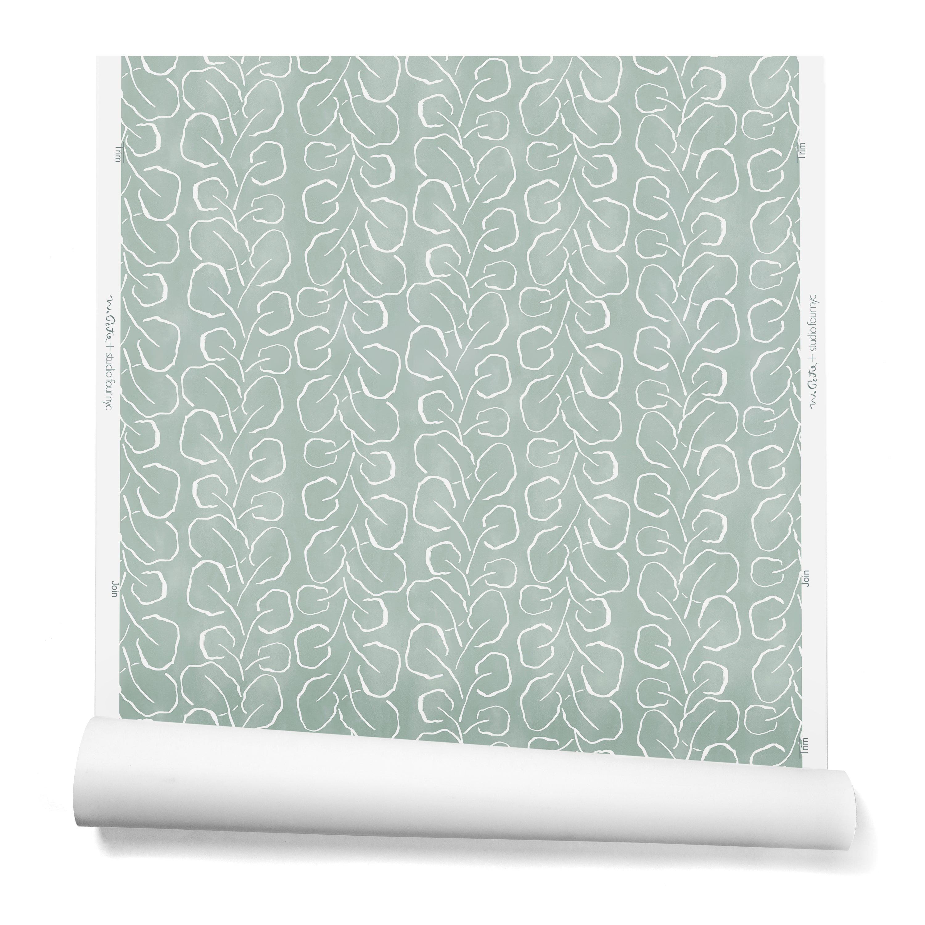 A hanging roll of wallpaper with a large-scale repeating leaf print in white on a sage green watercolor background.