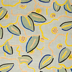 A swatch of fabric in a large-scale minimal floral print in shades of navy, yellow and pink on a gray-blue background.