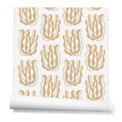 A hanging roll of wallpaper with a large-scale cartoon seaweed print in bronze on a white background.