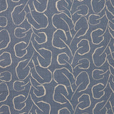 Woven fabric swatch with a large-scale repeating leaf print in tan on a French blue background.